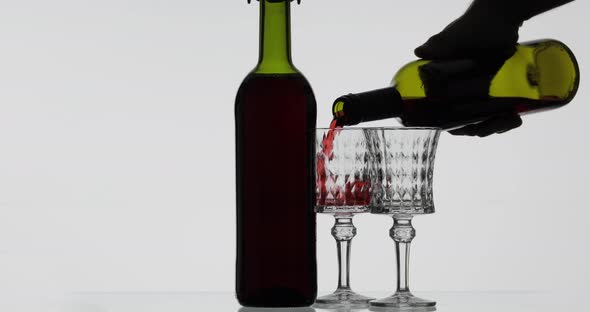 Rose Wine. Red Wine Pour in Two Wine Glasses Over White Background