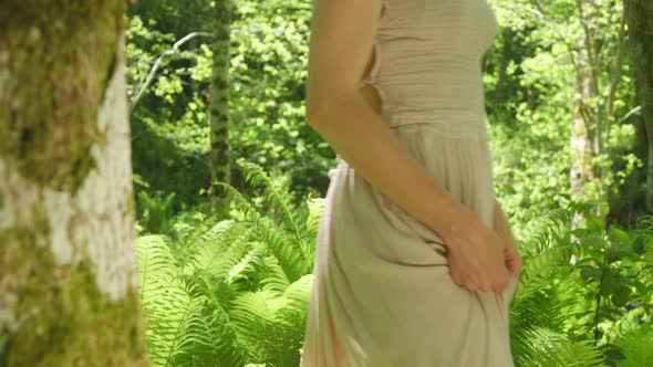 Girl Wearing Natural Dress Walking in the Fern Forest