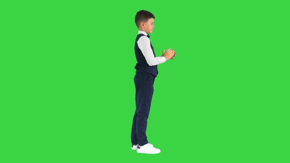 Concentrated Boy Using Digital Tablet While Standing on a Green Screen Chroma Key