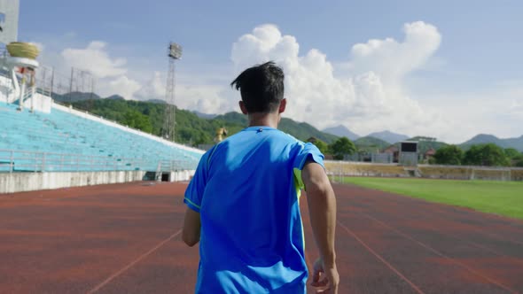 Runner Running On Stadium Track