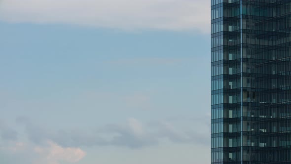 Timelapse Closeup Glass Skyscraper High Office Building Facade Moving Blue Sky and Clouds and