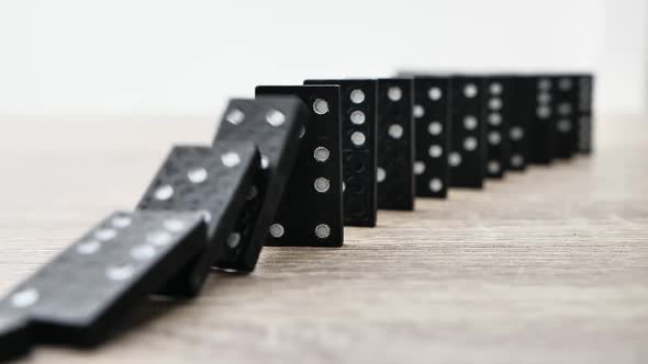 Domino Effect in Slow Motion  Falling Black Tiles with White Dots