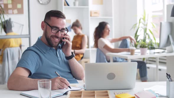 Caucasian Man Having Telephone Call in Office