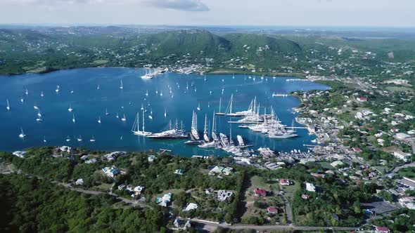 Air drone moves around the bay with white yachts at Falmouth Harbour, Antigua and Barbuda