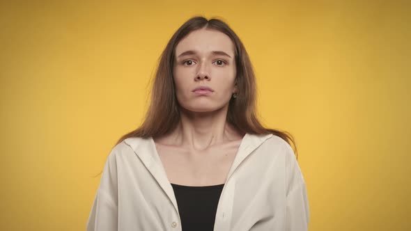 Woman Taking a Deep Breath and Exhale on a Bright Yellow Background