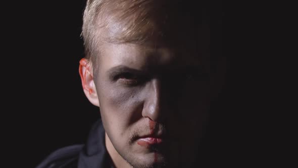 Halloween Man Portrait. Guy with Dripping Blood on His Face. Scary Makeup