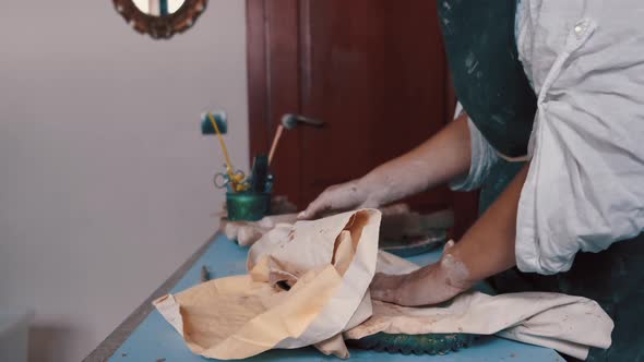 Potter Forming Clay Into a Dish By Using a Form and Tools To Get the Perfect Shape