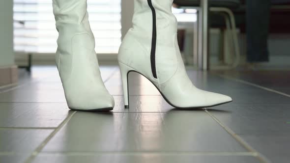 Woman walk in dirty white faux leather high heels stiletto boots