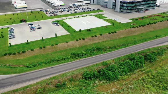 Modern industrial plant on field. Large factory among beautiful green nature.