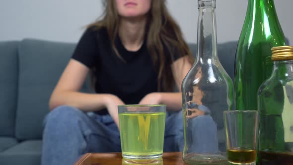 a woman suffers from a hangover, she drinks painkillers in a glass of water