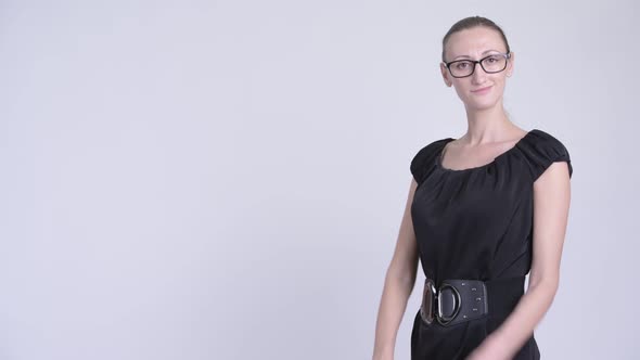 Profile View of Happy Blonde Businesswoman Smiling with Arms Crossed