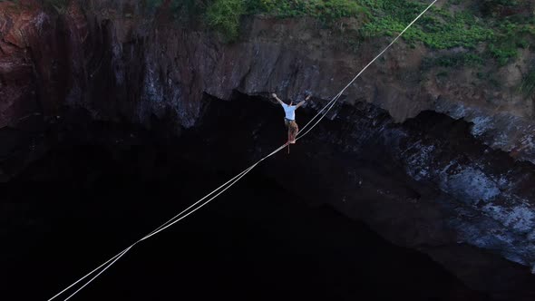 Aerial Footage of Man Walking on the Slackline Over the Massive Pit Film Grain