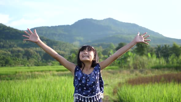 Little Girl Happy With Open Arms In Rice Field