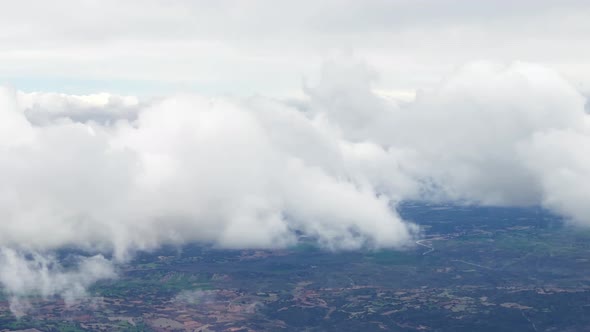 Entering and exiting into the clouds. Aerial view from a plane from Cuba landscape with cumulus clou