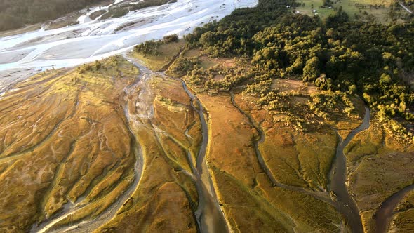 Tilt down aerial view of Rio Blanco, Hornopiren, Hualaihue, Chile. In the sunset light