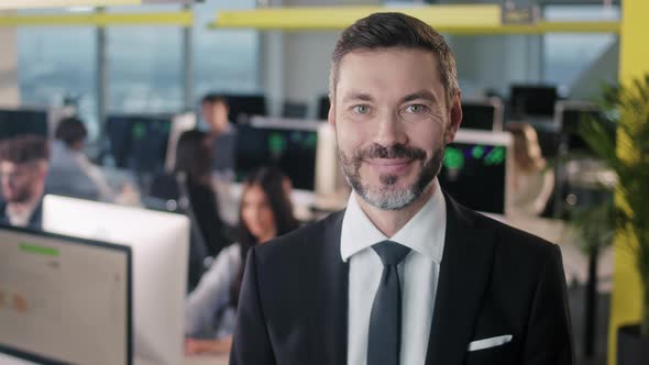 Portrait of Cheerful Male Boss with Beard Looking to Camera and Smiling