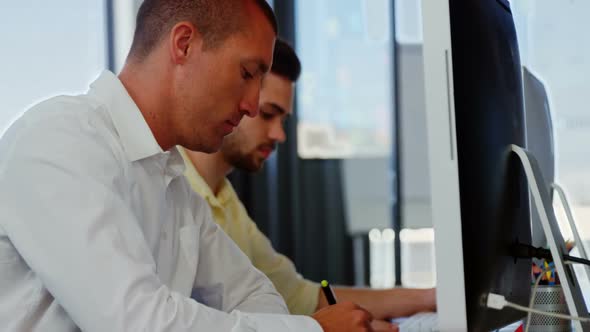 Business executives working over computer