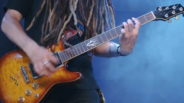 Guitarist Performs on Stage with Electro Guitar in Smoke