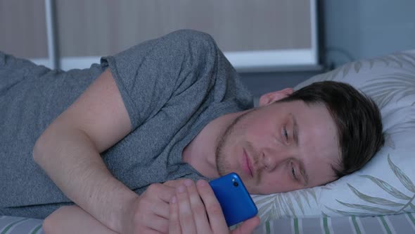 a Man Experiences a Feeling of Loneliness Lying on the Bed