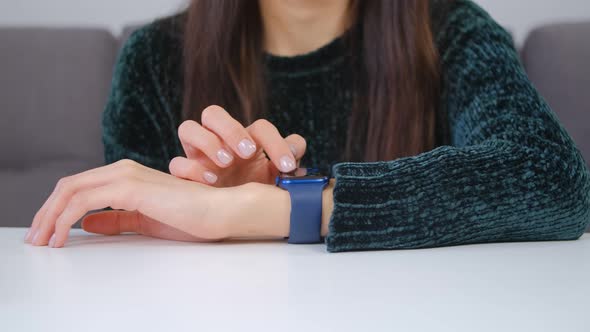Girl browsing notifications on modern smart wrist watches gadget in 4k video
