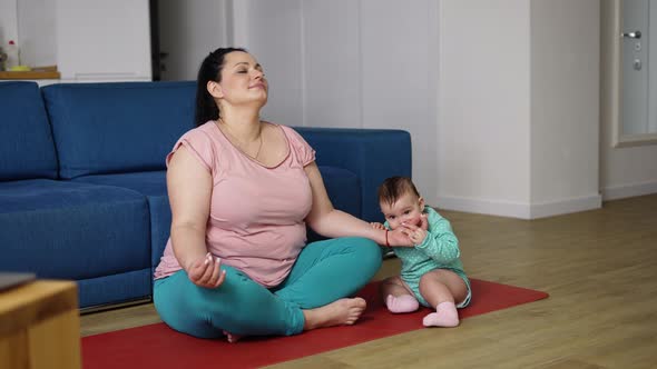 Plus Size Woman Disturbed By Her Baby While Sitting on the Floor in Meditation Slow Motion