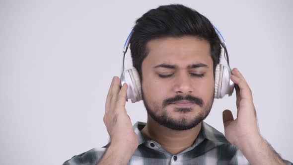 Portrait of Young Bearded Indian Man Listening To Music