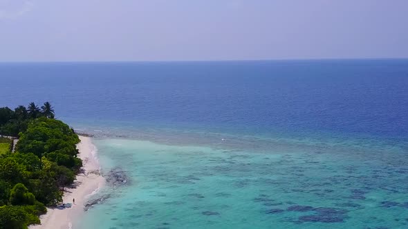 Aerial drone landscape of shore beach by blue lagoon and sand background