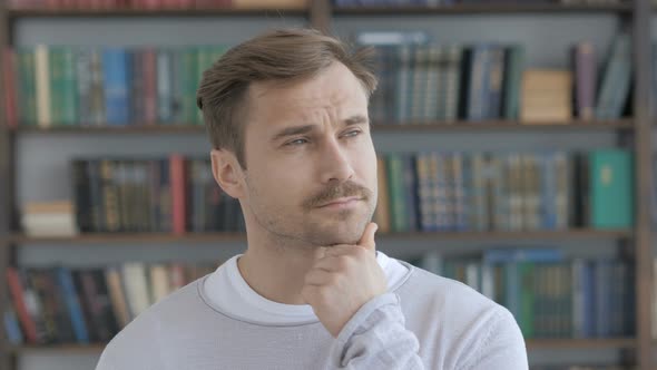 Portrait of Thinking Middle Aged Man in Office