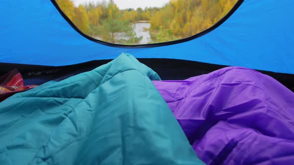 View to River From Camp Tent with Sleeping Bags