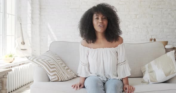 Happy Black Mixed Woman Looking at Web Camera Waving Hand and Greeting