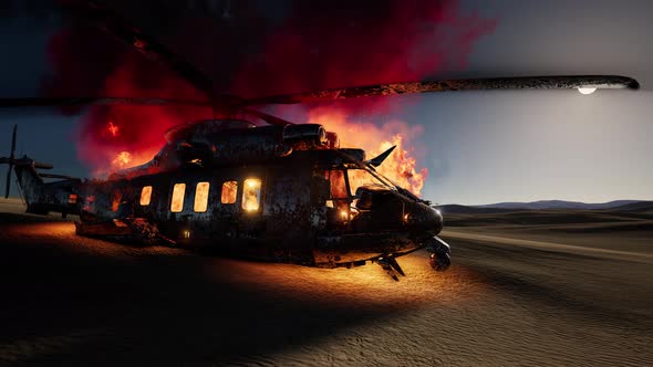 Burned Military Helicopter in the Desert at Sunset