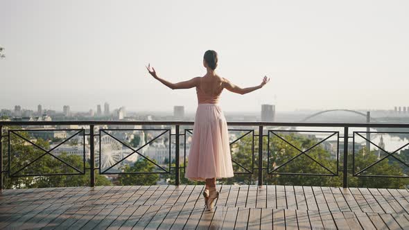 Graceful Woman in Pointe Shoes Dances on Observation Deck