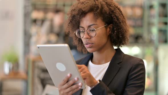 Serious African Businesswoman Using Digital Tablet