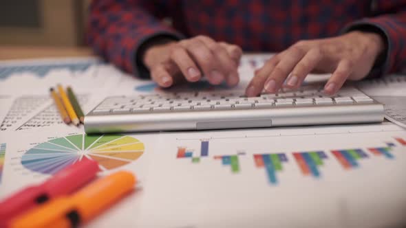 The Businessman Examines Documents with Diagrams and Graphs