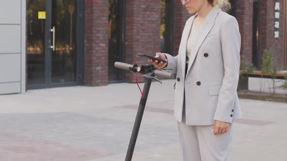 Businesswoman Using E-Scooter in City Downtown