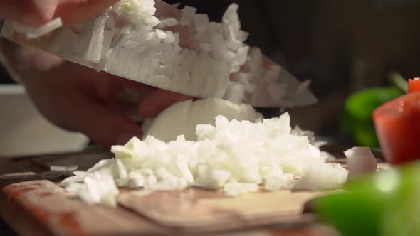 Slicing White Onion In Small Dice. - close up