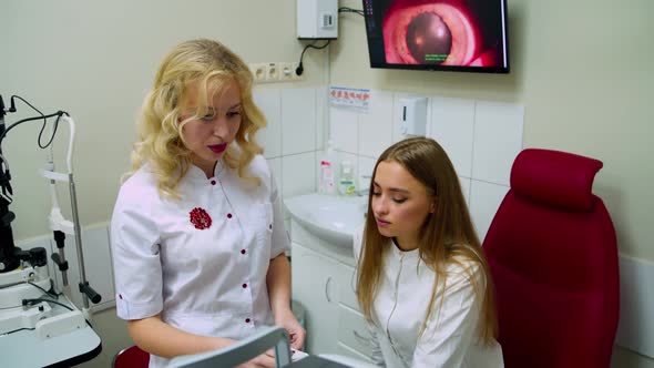 Doctor checking patient at eye clinic. Optometrist doing vision testing for patient in hospital