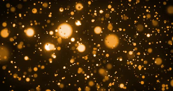 Animation of glowing gold spots of light moving in hypnotic motion on brown background