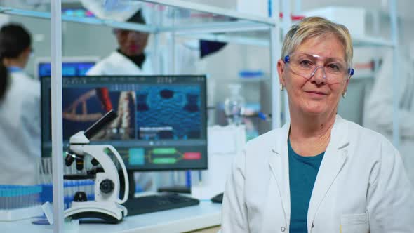 Portrait of Elderly Scientist Woman Smiling at Camera