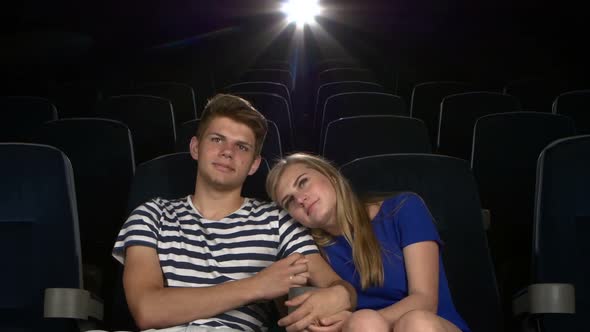 Great Movie! Young Couple Feeding Each Other at the Cinema