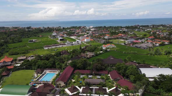 Canggu, Bali Indonesia, drone flight over the city looking out across the ocean