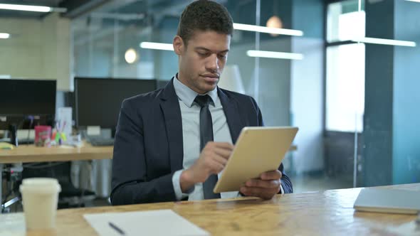 Sad Young African Businessman Having Loss on Tablet