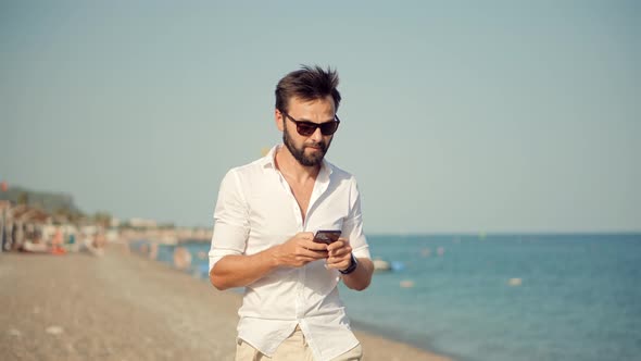 Freelancer Remote Working At Seacoast Beach Using Mobile Phone Call To Colleagues. Mobile Worker.