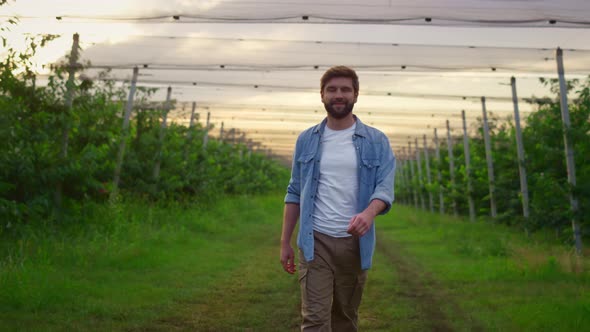 Happy Farmer Enjoying Harvest in Orchard