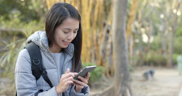 Woman use of mobile phone in the park