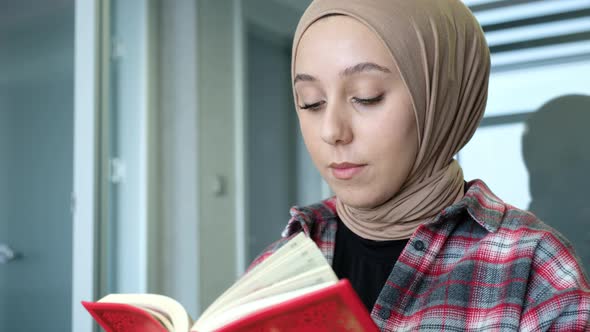 Muslim beautiful woman is reading the Koran.