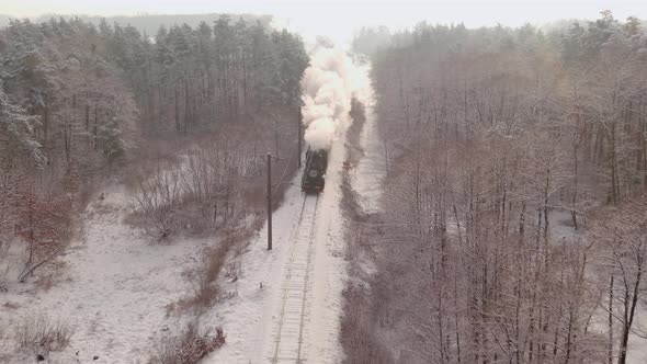 Aerial of an Antique Restored Steam Locomotive Blowing Smoke Steam Traveling