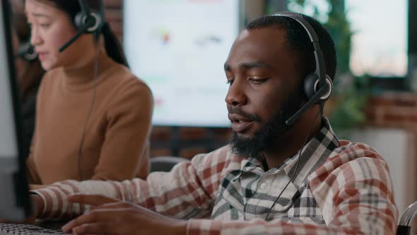 Young Man Answering Telework Call at Customer Service Job