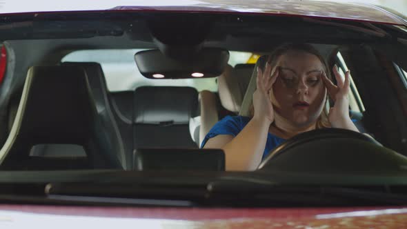 Overweight Woman Behind Wheel of Car Suffering From Stress