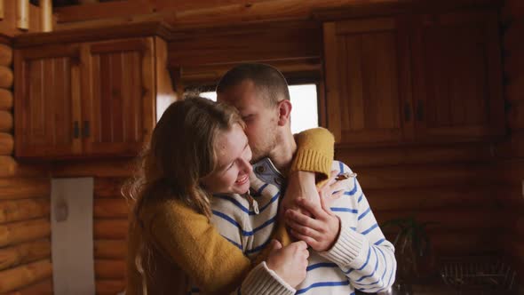 Caucasian couple spending time at home together, looking at the window